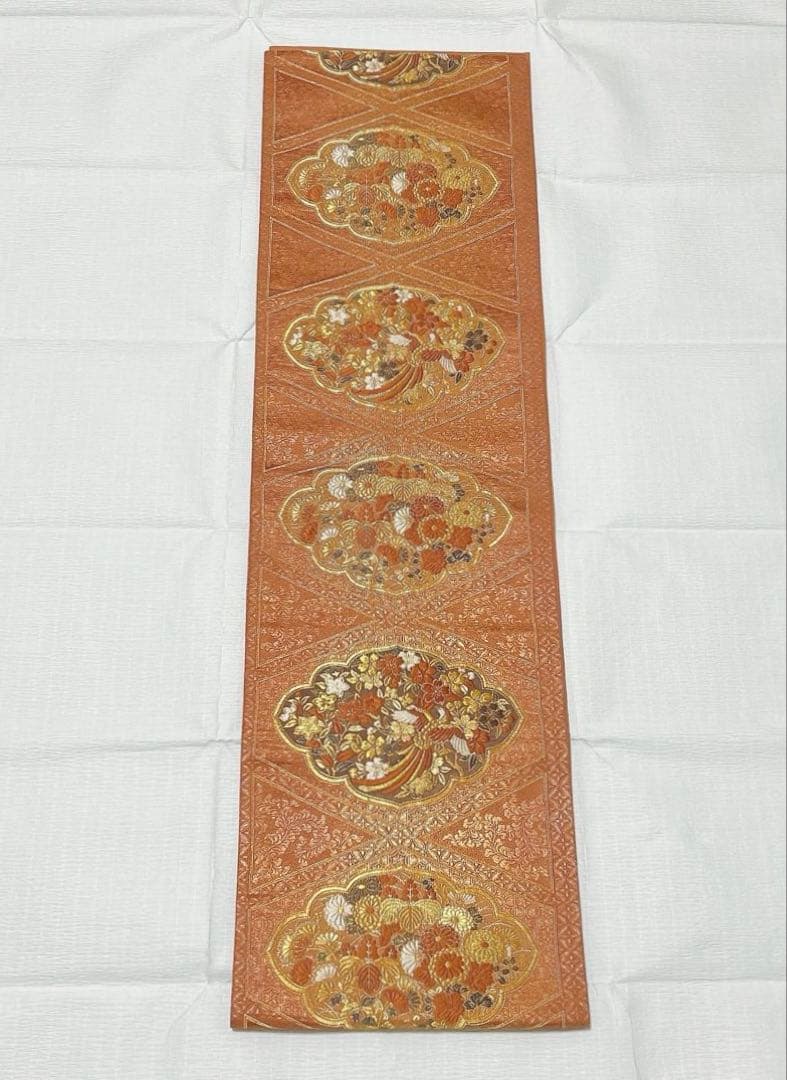 梅垣織物　袋帯　西陣織　七宝菱蒔絵文　正絹　金糸　オレンジゴールド系　逸品