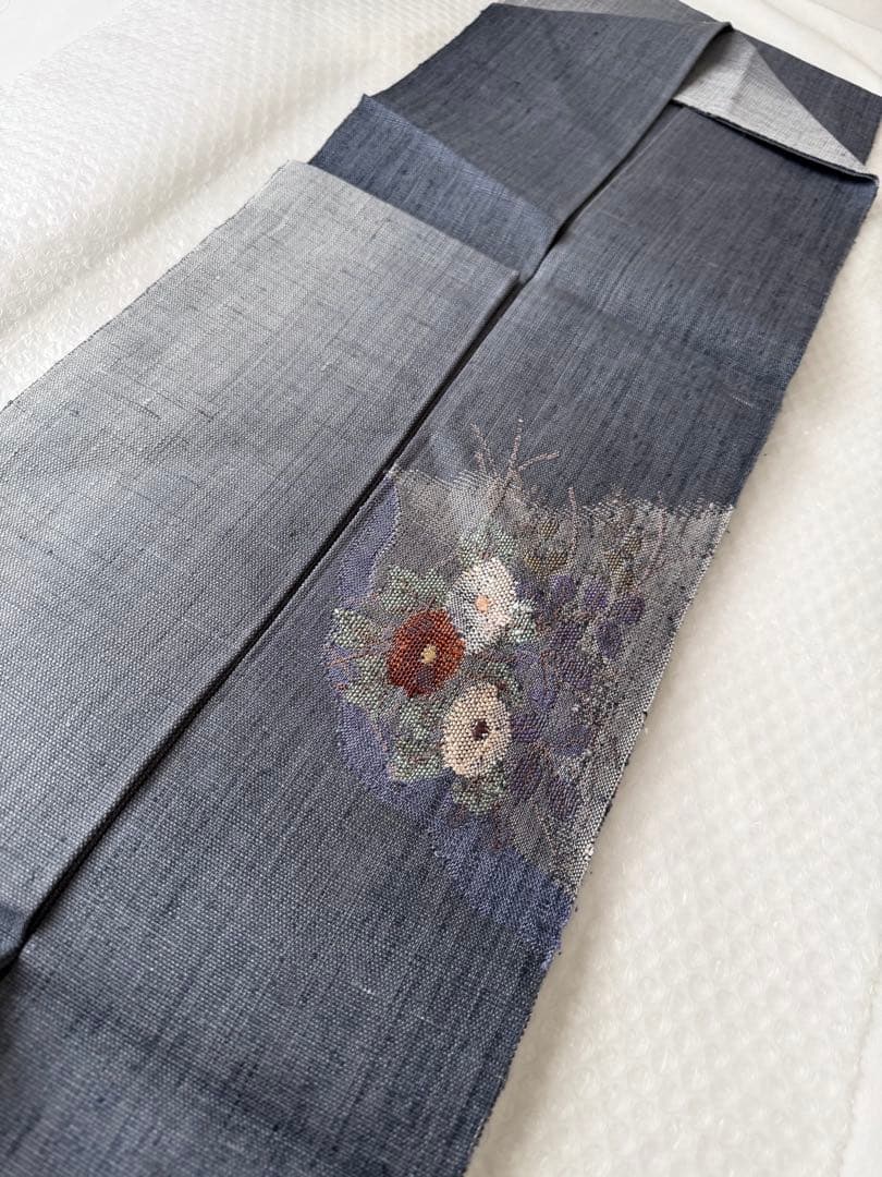 N34 美品 手織り真綿紬 万寿菊模様織出し 正絹 名古屋帯 ブルーグレー 暈し