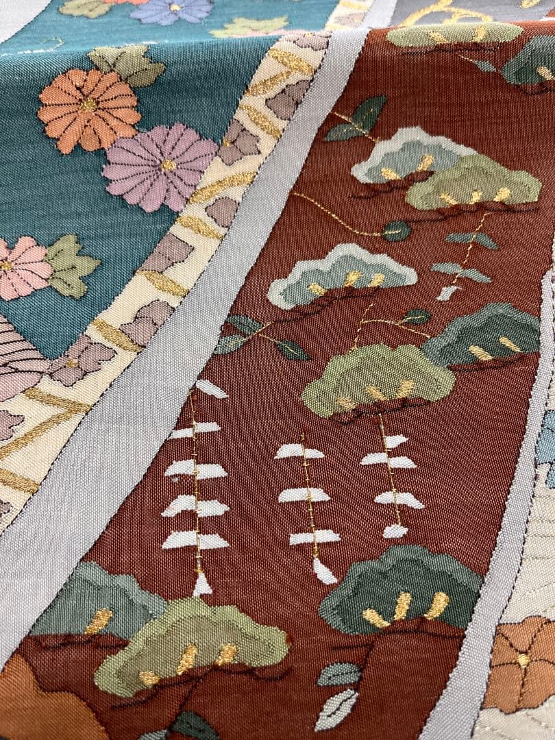 仕立て上がり新品袋帯　薄いグレーに鶴松花宝尽くしなどおめでたい柄　とても可愛い